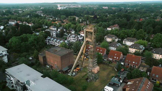 Aerial scenic view of old closed coal mine head in a residential area in Europe, Germany.