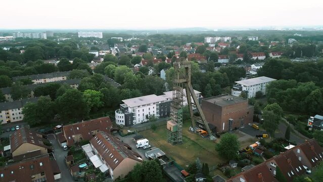Aerial scenic view of old closed coal mine head in a residential area in Europe, Germany.