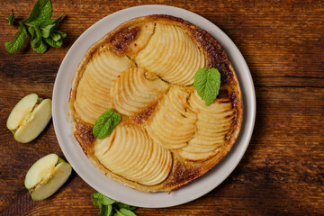 French apple pie on wooden background. Top vii.