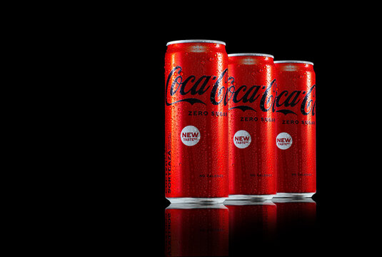 Zaporozhye, UKRAINE - MAY 28, 2023: Coca-Cola zero sugar cans with water drops and reflection on black background.