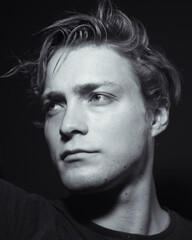 Fototapeta premium Monochrome shot of a male model in a dark room