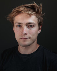 Fototapeta premium A man in a dark room looking directly at you