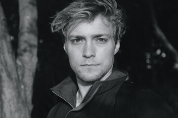 Obraz premium Black and white shot of a man in woodland