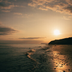 Waves on the beach at sunset