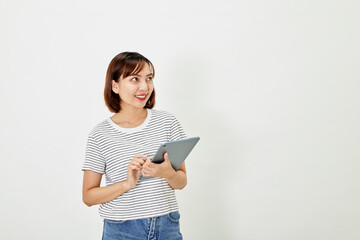 Asian woman company worker smiling and holding digital tablet standing