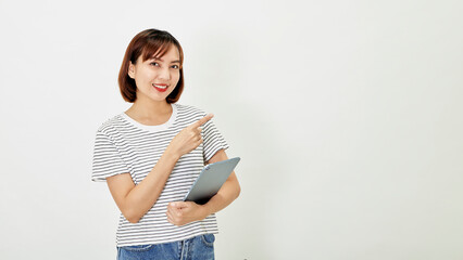 Asian woman company worker smiling and holding digital tablet standing