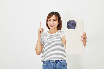 Young Asian female in t-shirt and blue jeans showing smartphone