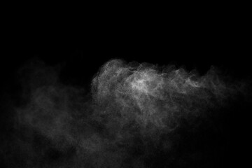 Close-up of steam or abstract white smoke rising above. from humidifier spray isolated on a black background