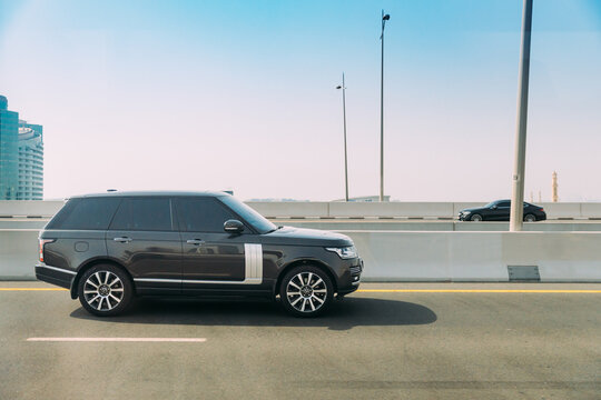 Dubai, UAE, United Arab Emirates - May 28, 2021: Black 2013 Range Rover Vogue car fast mooving on street in Dubai. Land Rover Range Rover Voque is series of subcompact luxury crossover SUVs developed
