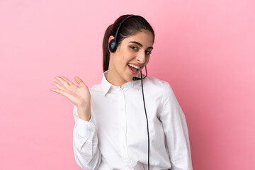 Young telemarketer over isolated background saluting with hand with happy expression