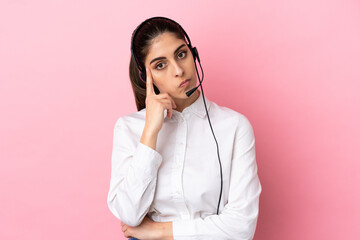 Young telemarketer over isolated background thinking an idea