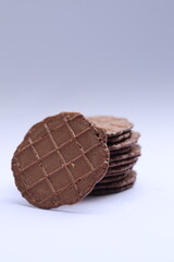 Close up photo of Chocolate wafer cookies with gold leaf arranged with statistics concept on white background.