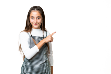 Young girl over isolated chroma key background pointing to the side to present a product