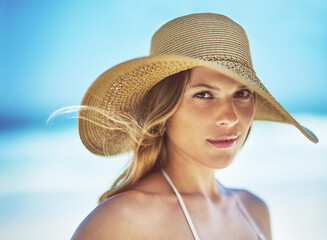 Travel, vacation and portrait of woman at beach for summer, tropical and relax mockup. Wellness, nature and holiday with face of female tourist and hat at seaside for sunbathing and paradise