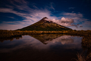 Fototapeta premium New Zealand, Mount Taranaki is the symmetrical volcanic cone that rises from sea level to 8,260 ft (2,518 m). This mountain is located in Egmont National Park, North Island of the New Zealand.