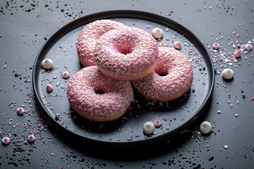 Tasty and colorful pink donuts as popular snack.