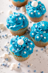 Beautiful and unique cupcakes with sprinkles and blue cream.