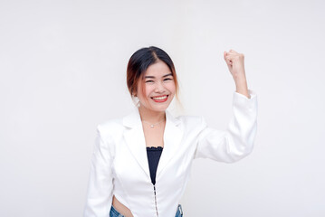 A cheerful young woman with her right arm raising up showing power and strength. Isolated in a white background.