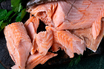Hot smoked trout fillet on dark board. Close-up. Top view - 611630544