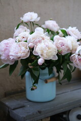 peonies in an enamel can in a vintage farmhouse style