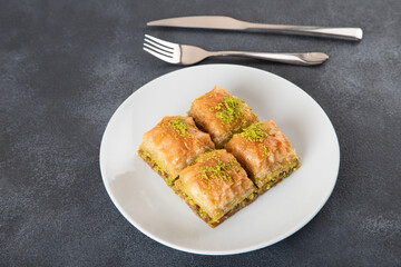 Pistachio Turkish baklava on a white plate.Traditional delicious Turkish baklava
