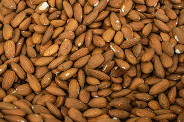 Image of almonds with skin stocked in market for consumption.
