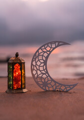 Eid Mubarak background, half moon shape with colourful lantern lamp in the beach