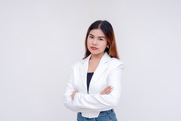 An irate and angry young woman arms crossed and staring blankly into the camera. Isolated on a white background. - obrazy, fototapety, plakaty