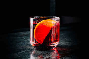 Cocktail Negroni with gin, campari martini rosso and orange. negroni cocktail on table