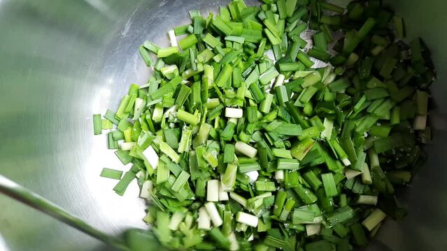 Stir sliced Garlic Chives and Ingredients for making steamed dumpling stuffed with garlic chives, chinese chives dim sum.
