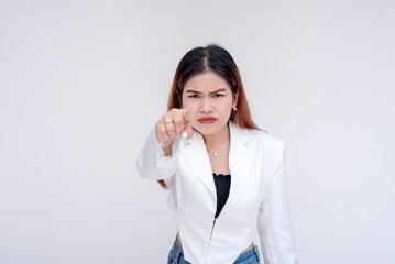 An irked and irritable young woman glaring and pointing at the camera. Isolated on a white background. - obrazy, fototapety, plakaty