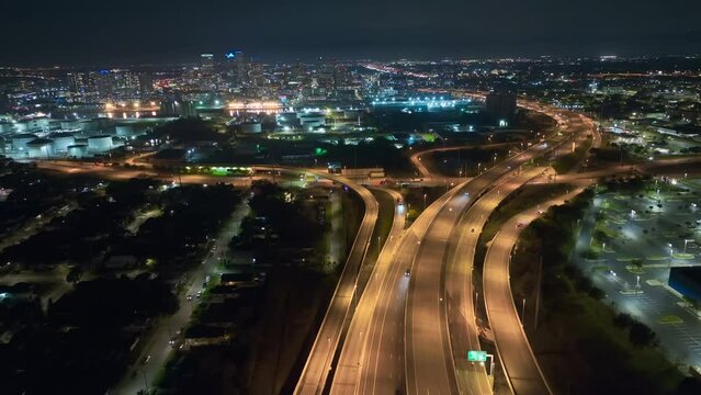 View from above of american big freeway intersection in Tampa, Florida at night with fast moving cars and trucks. USA transportation infrastructure concept