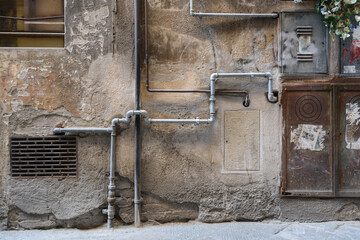 A frontal photo of a facade with water and gas tubs 