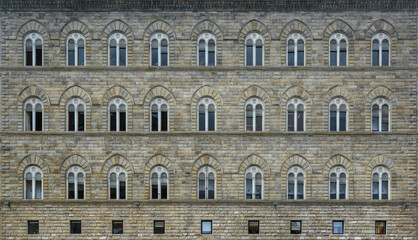Fototapeta na wymiar Frontal photo of a stone facade of a building in Florence 