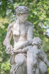 Dresden, Germany - Statue of Venus cutting wings to an angel in the citizen meadow park called...