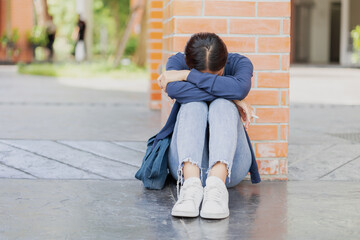 Teen girl sad cry from fail exam. University Student tired sitting down sleep or mental sick © Quality Stock Arts