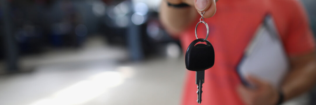 Person Mechanic Handing Over Key To Car In Workshop. Guarantee Of Quality Auto Repair Concept