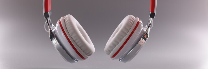 White red modern headphones on gray background. Headphones-headset for computer and phone concept
