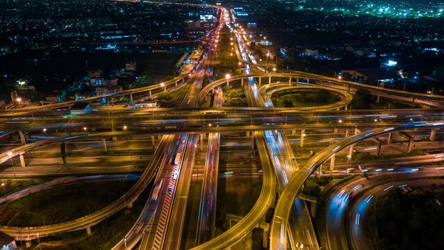 Aerial view of traffic on massive highway intersection at night.