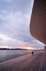 Beautiful sunset. Museum of Art, Architecture and Technology on the Tagus River promenade at Lisbon, Portugal.