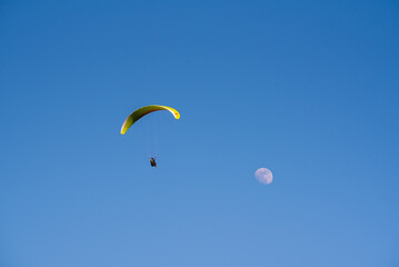 Player flying towards the moon with blue sky