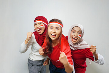 happiness of a group of young people using the red and white attributes to commemorate independence day