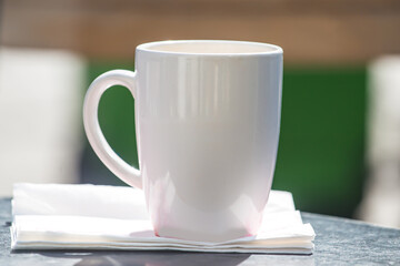 white cup of coffee on white paper.