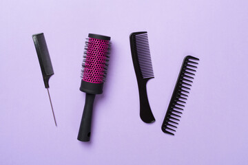 Professional combs and hairdresser tools on color background, top view