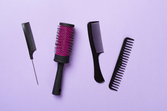 Professional combs and hairdresser tools on color background, top view