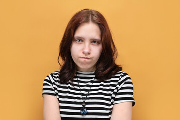 Fototapeta premium A young teenage girl is very sad, her pet has died and the girl is suffering a lot, constantly crying, she has bruises under her eyes. Unhappy teenage girl