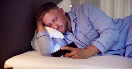 Man In Bed With Mobile Phone