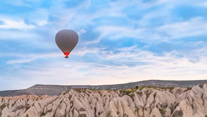 Foto auf Acrylglas Cappadocia. Hot air balloons flying over Cappadocia in a dramatic sky. Travel to Turkey. Selective focus included. © Mete Caner Arican