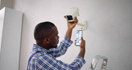 African American Using Security And Alarm System