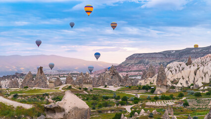 Cappadocia. Hot air balloons flying over Cappadocia in a dramatic sky. Travel to Turkey. Selective...